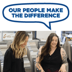 Two women speaking in a showroom. A talk bubble graphic above their head saying "Our people make the difference".