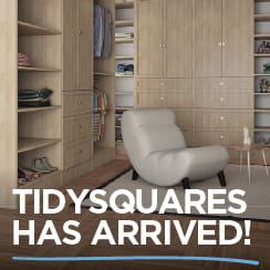 A promotional image showing wooden cabinetry shelves and drawers with a white chair in front, with the text 'TIDYSQUARES HAS ARRIVED!' at the bottom.