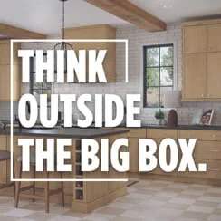 A modern kitchen with light wooden cabinets and the text 'THINK OUTSIDE THE BIG BOX.'
