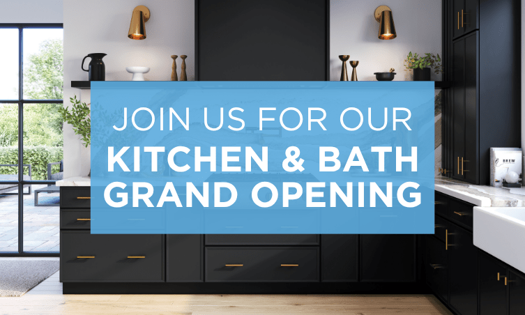 A promotional image for the grand opening of a kitchen and bath store, showcasing a modern kitchen design with a large banner reading 'Join Us For Our Kitchen & Bath Grand Opening'.