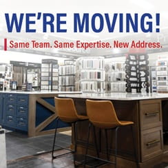 Interior view of a store with a sign announcing 'We're Moving! Same Team. Same Expertise. New Address.'
