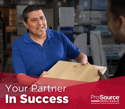 ProSource Wholesale employee showing flooring sample to a client, with text 'Your Partner In Success'.