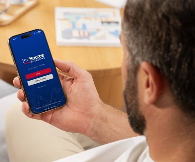 Man looking at his phone to log into the Trade Pro App