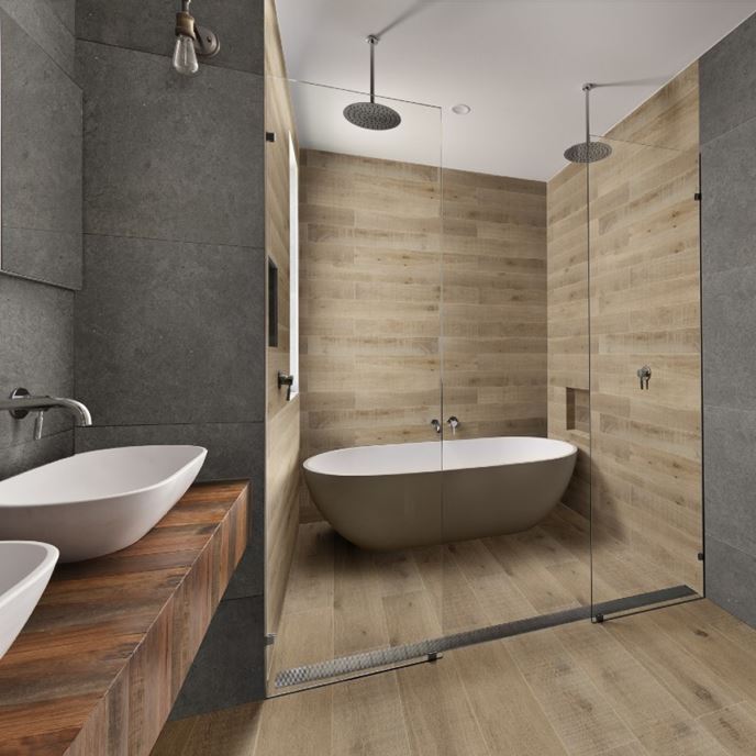 This modern wet room blends natural textures with spa-like functionality. Dual rain showerheads, a freestanding tub, and sleek wood-look tile offer a seamless design that’s as stylish as it is practical.